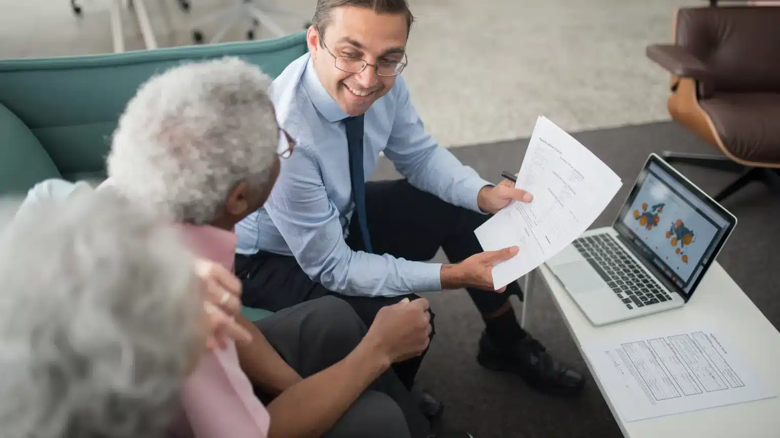 Inheritance Tax on Pensions: The 2027 Change Every Retirement Saver Needs to Plan For Now Financial adviser going through pension and estate paperwork with a retired couple