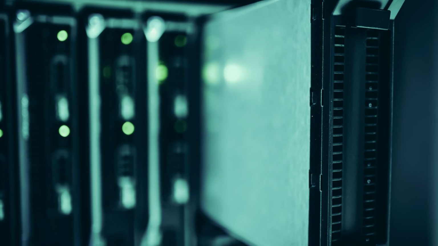 Server equipment in a data centre with illuminated indicator lights on dark-coloured hardware units