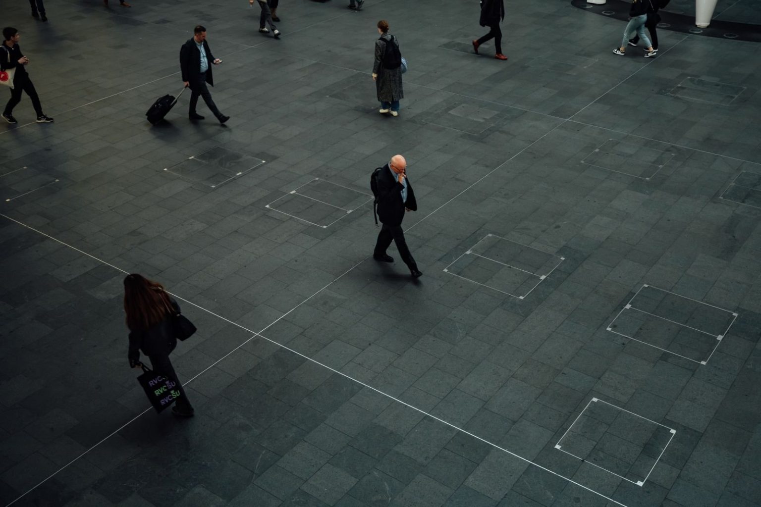 Commuters walking through a plaza in London
