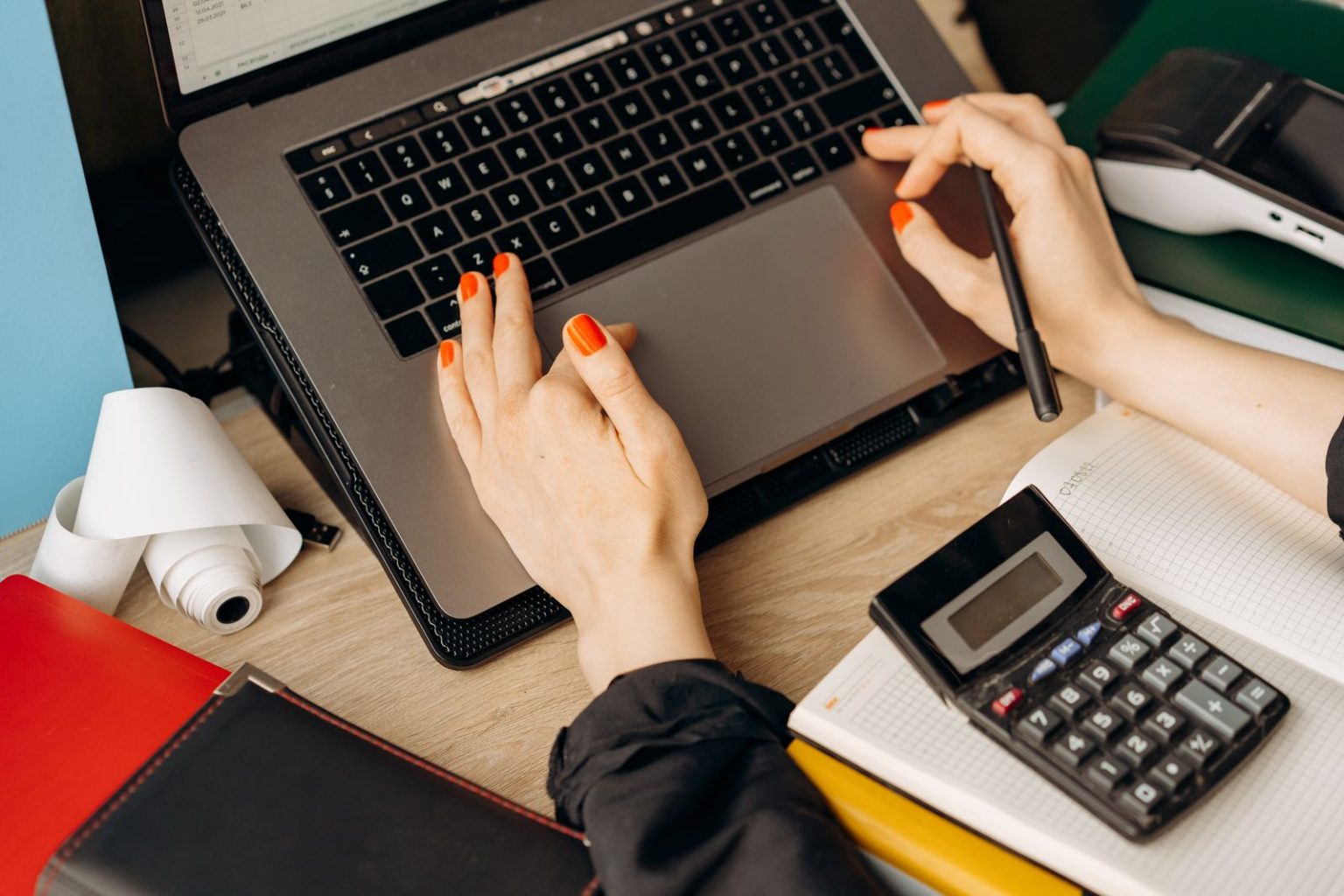 The First-Year Financial Checklist for a New Limited Company A company director reviewing the books on a laptop with a calculator during the first financial year